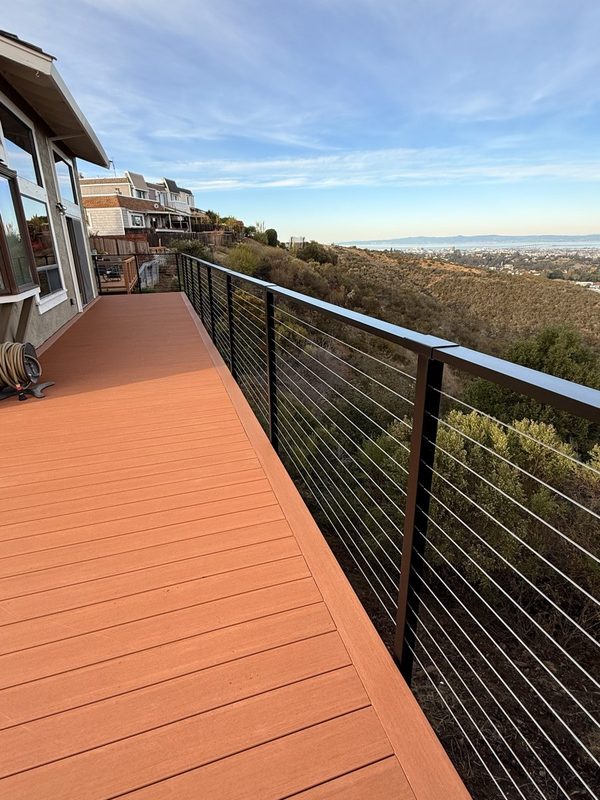 The same Hillsborough frame finished: composite deck and cable railing over the hill