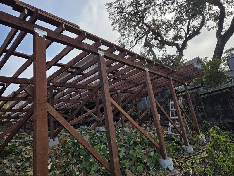 Posts, beams and diagonal bracing under a deck on a slope, Los Gatos