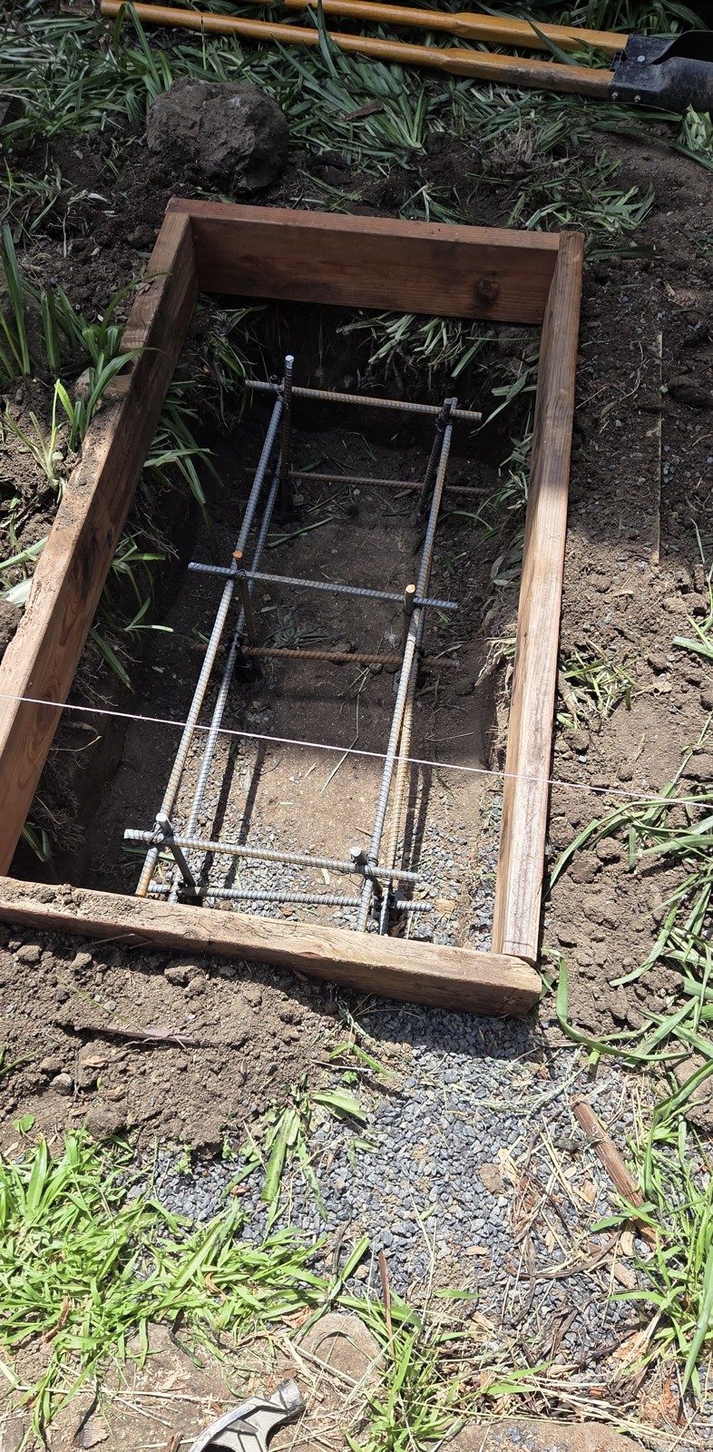 Wood form with rebar for a new concrete deck footing