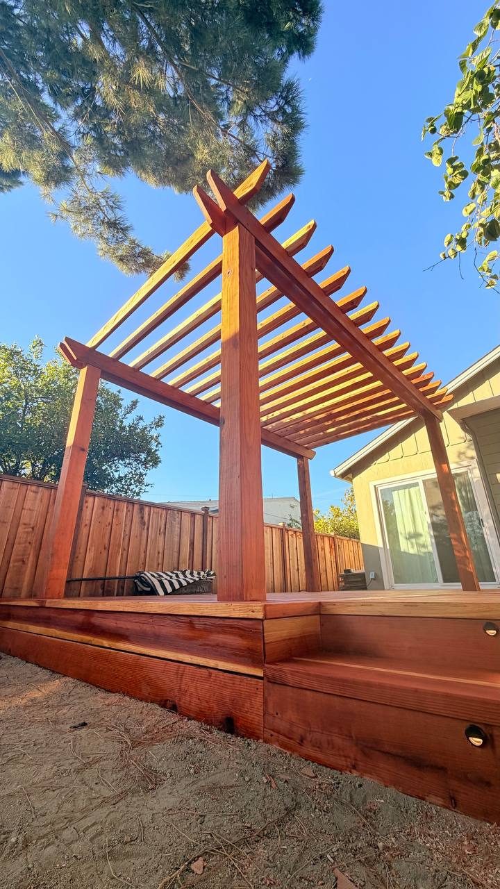 Round light set flush into a redwood riser under a pergola, San Jose