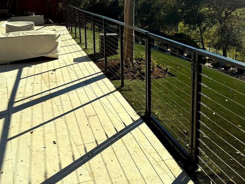 Aluminum cable railing along a stone terrace, built by MS Construction and Services