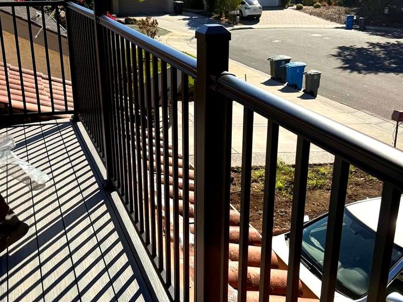 Powder-coated aluminum railing on a composite deck above the roofline, built by MS Construction and Services