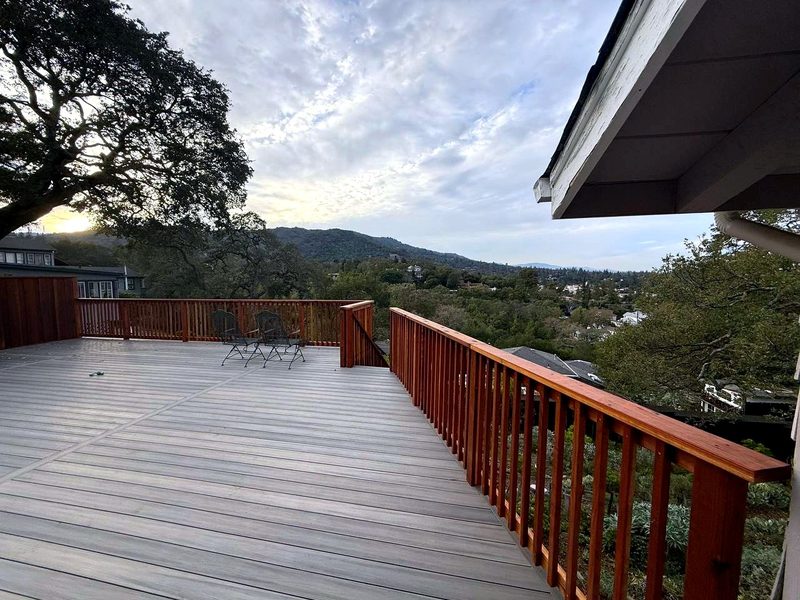 Redwood picket railing around a composite deck over a hillside, built by MS Construction and Services