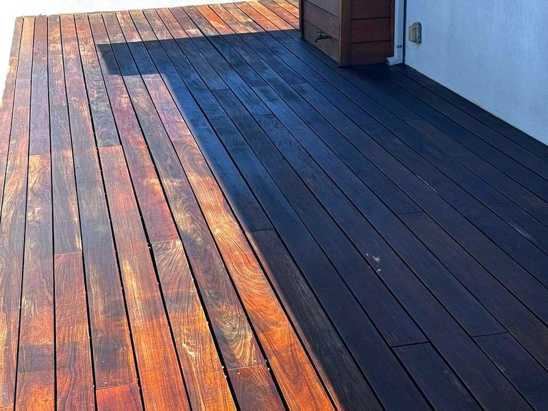 Dark stain next to boards just sanded to bare wood, by MS Construction and Services