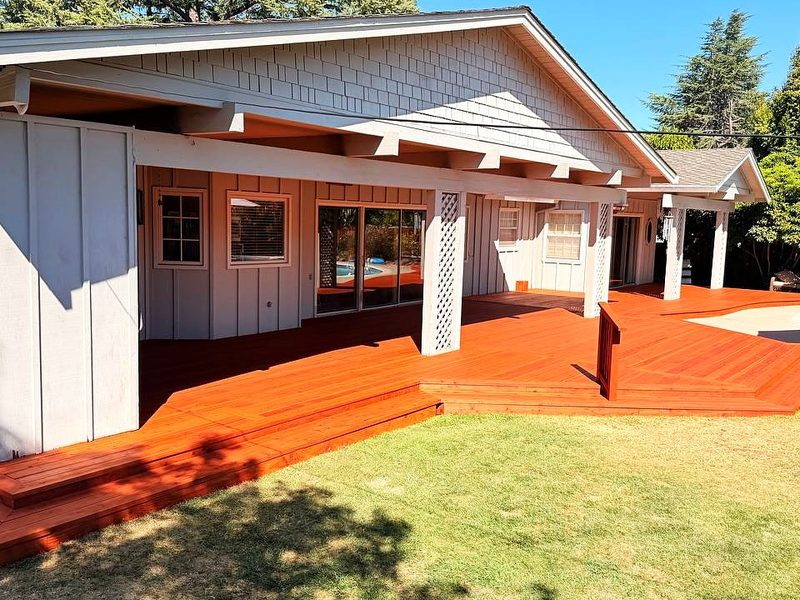 Wraparound redwood deck by the pool, built by MS Construction and Services
