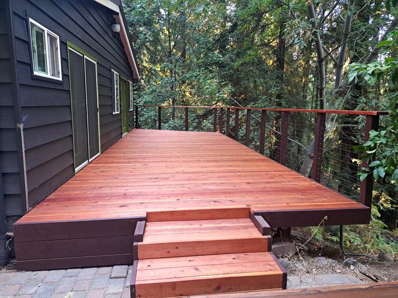 Redwood deck with cable railing among the trees, built by MS Construction and Services