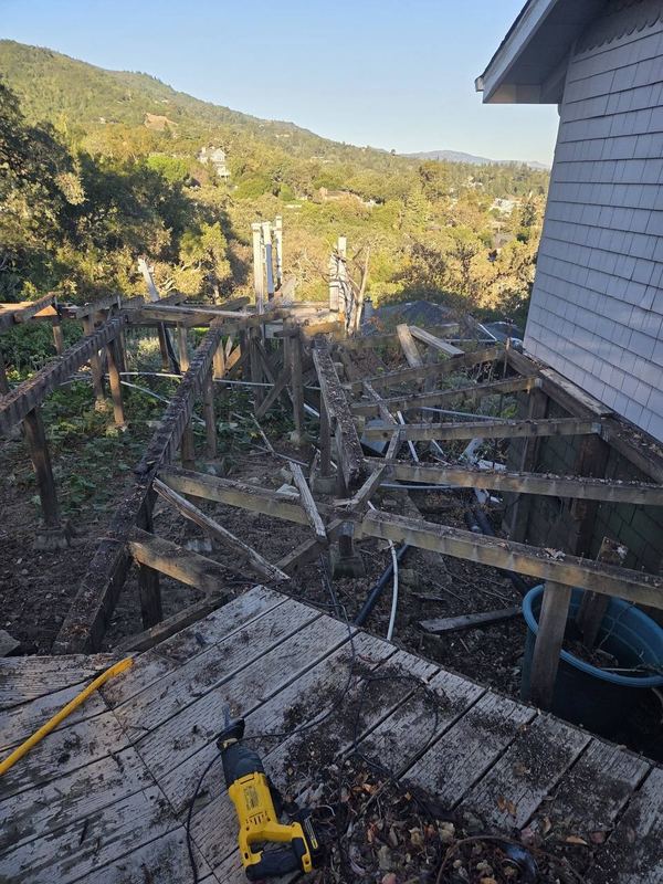 The old deck stripped to its frame before the rebuild