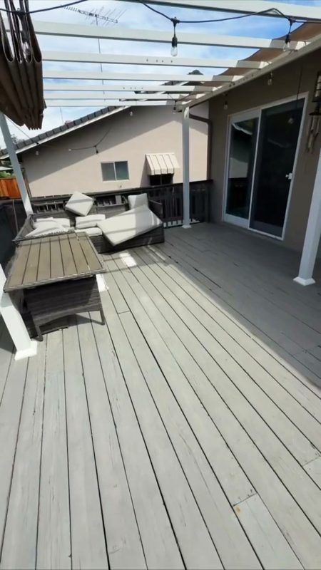 The old deck: gray boards, white railing