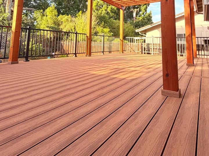 Eva-Last Apex Plus decking in Chestnut Cedar under a redwood pergola with aluminum picket railing, San Jose (Almaden)