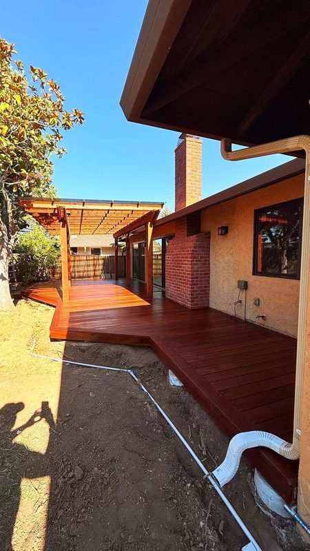 Cumaru deck and redwood pergola along the house