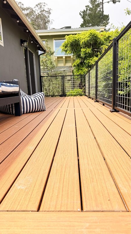 Finished Trex Signature deck in Ocracoke along the house, with mesh railing, Half Moon Bay