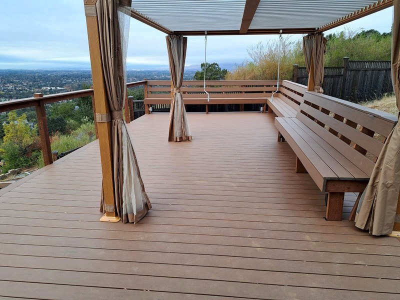 Trex Transcend Lineage deck in Jasper with cable railing and built-in benches under a pergola, Los Gatos