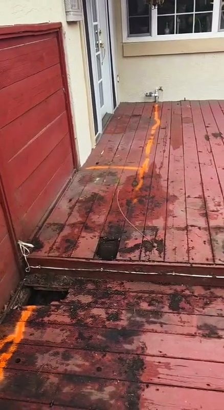 Soft, stained boards along the house wall