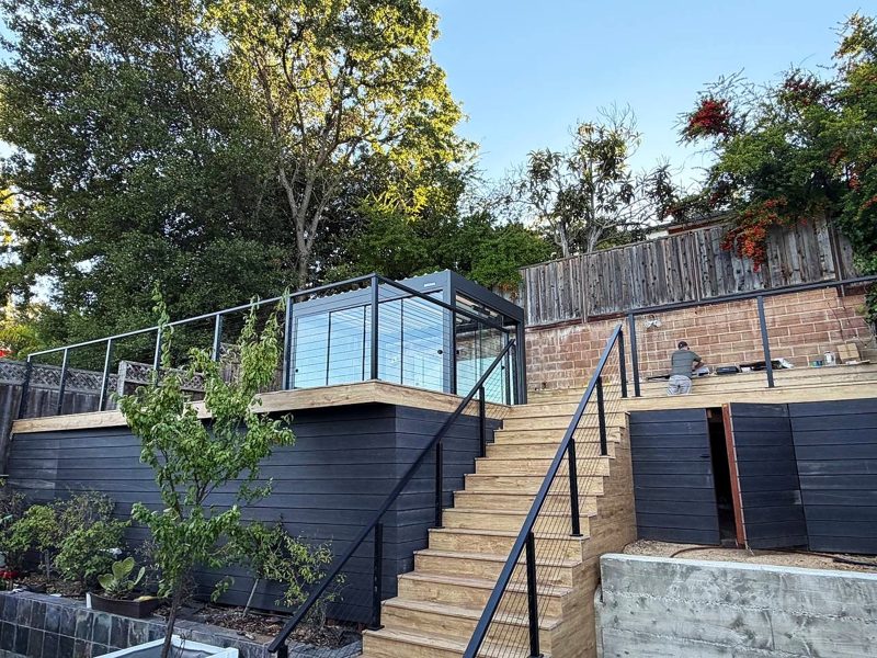 San Carlos — Hillside deck with cable railing and a glass-wall pergola