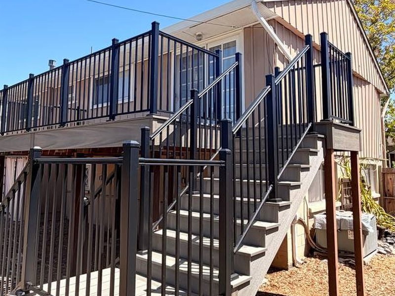 Second-story Eva-Last composite deck with new stairs and black aluminum picket railing in San Jose