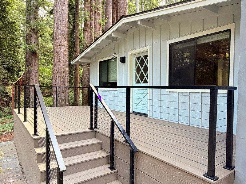 Eva-Last Apex Plus deck in Brazilian Teak with stairs, skirting and aluminum cable railing among redwoods, Scotts Valley