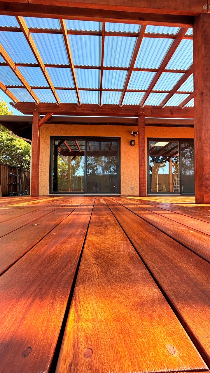 Redwood deck under a pergola built by MS Construction and Services